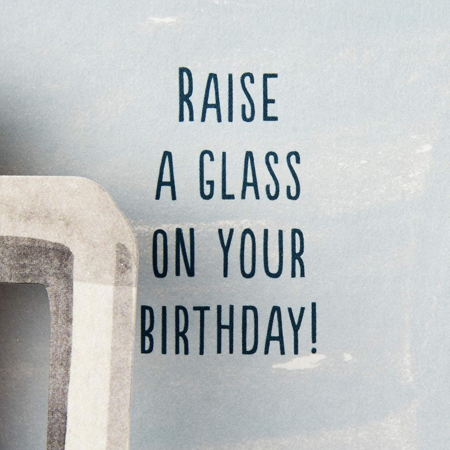 Hallmark Paper Wonder Displayable Pop Up Birthday Card (Beer) close up of greeting message 'Raise a glass on your birthday!'.   