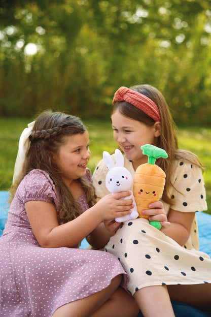 Bunny and Carrot Magnetic Plush – Better Together in the hands of two smiling girls outdoors, dressed in playful outfits.