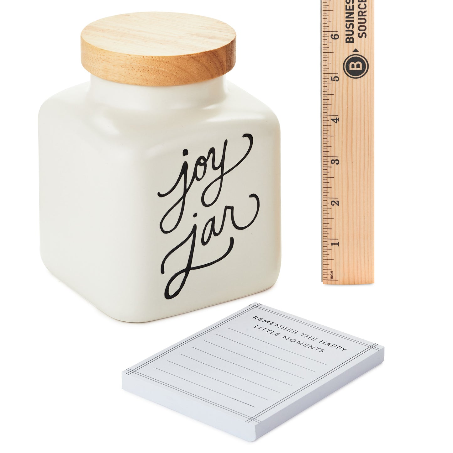Ceramic joy jar and notepad set with wooden lid, featuring black lettering and ruler for size reference.