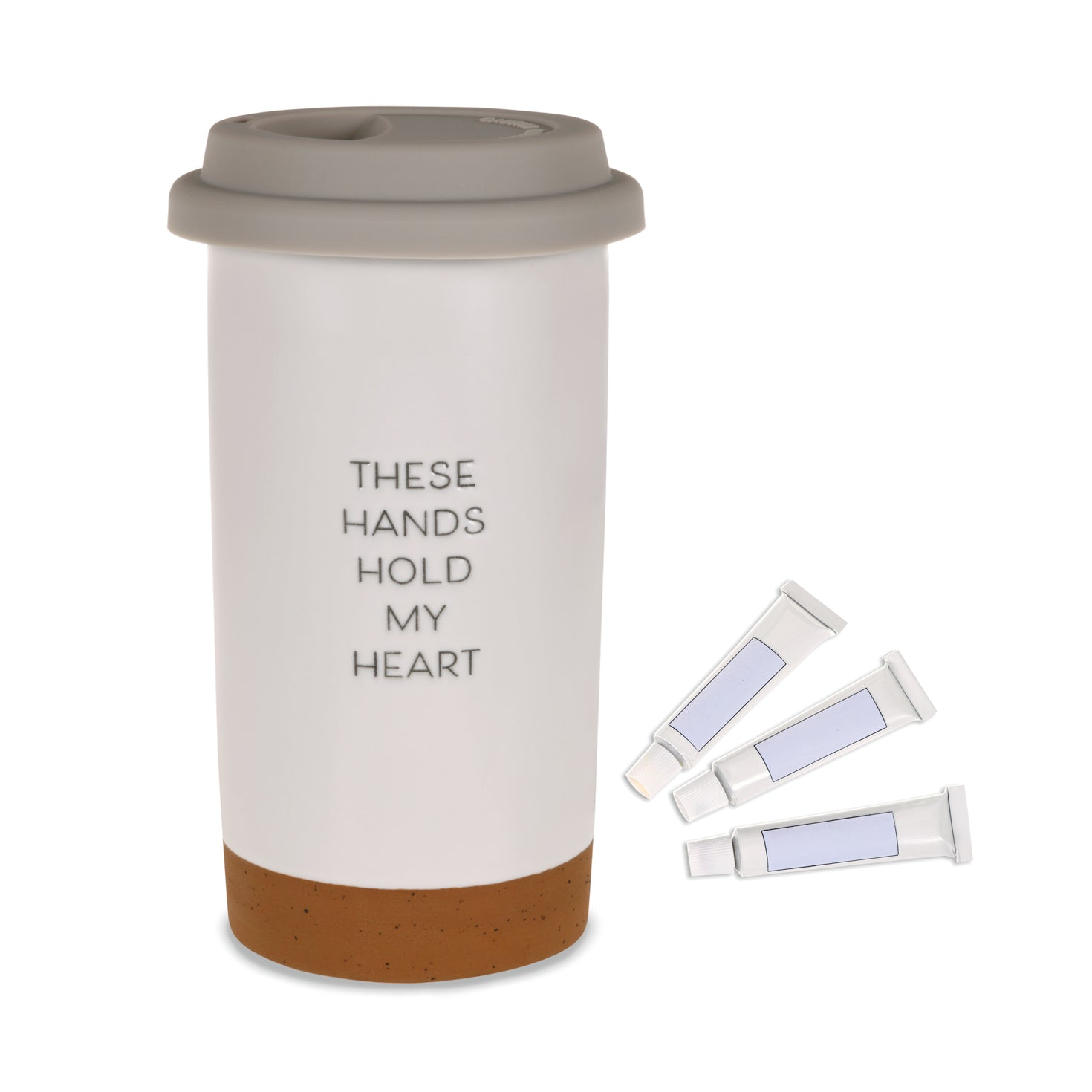These Hands Hold My Heart Ceramic Travel Mug, 12.5 oz. with grey silicone lid and three paint tubes for DIY decoration.