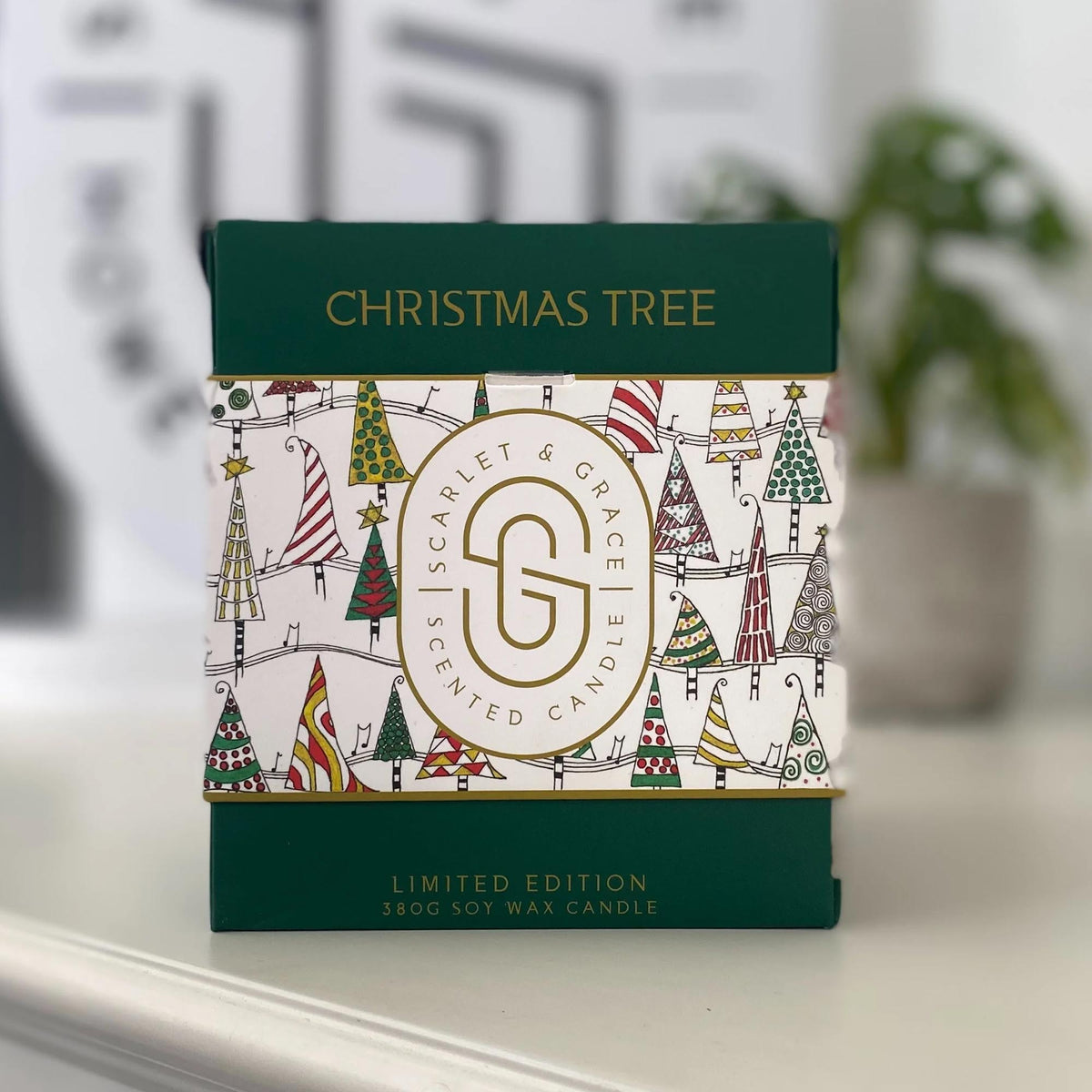 Christmas Tree Candle - Limited Edition (380g) in decorative packaging featuring festive tree patterns, displayed on a surface.