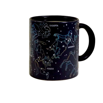 Unemployed Philosophers Guild - Constellation Mug in black ceramic displaying 11 constellations against a starry background, angled view.