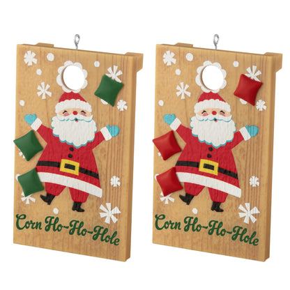 Corn Ho-Ho-Hole — 2025 Hallmark Keepsake Christmas Ornament, colourful Santa design, detailed wooden cornhole boards in a flat lay view.
