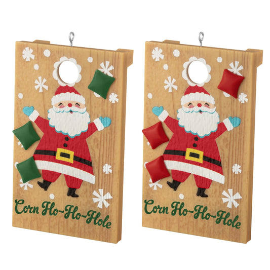 Corn Ho-Ho-Hole — 2025 Hallmark Keepsake Christmas Ornament, colourful Santa design, detailed wooden cornhole boards in a flat lay view.