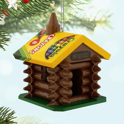 Crayola®, Colourful Log Cabin — 2025 Hallmark Keepsake Christmas Ornament, brown crayon structure with colourful roof, angled view.