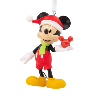 Hallmark Christmas ornament - Disney Mickey Mouse holding ornament, colourful figurine wearing a Santa hat and green scarf, detailed close-up.