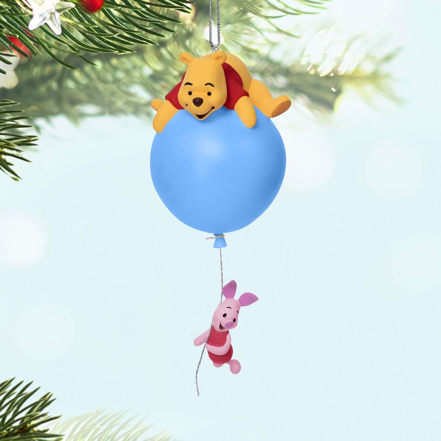 Disney, Winnie the Pooh: Up for Adventure Ornament With Light — 2025 Hallmark Keepsake Christmas Ornament featuring Pooh and Piglet on a blue balloon, hanging from a tree branch.