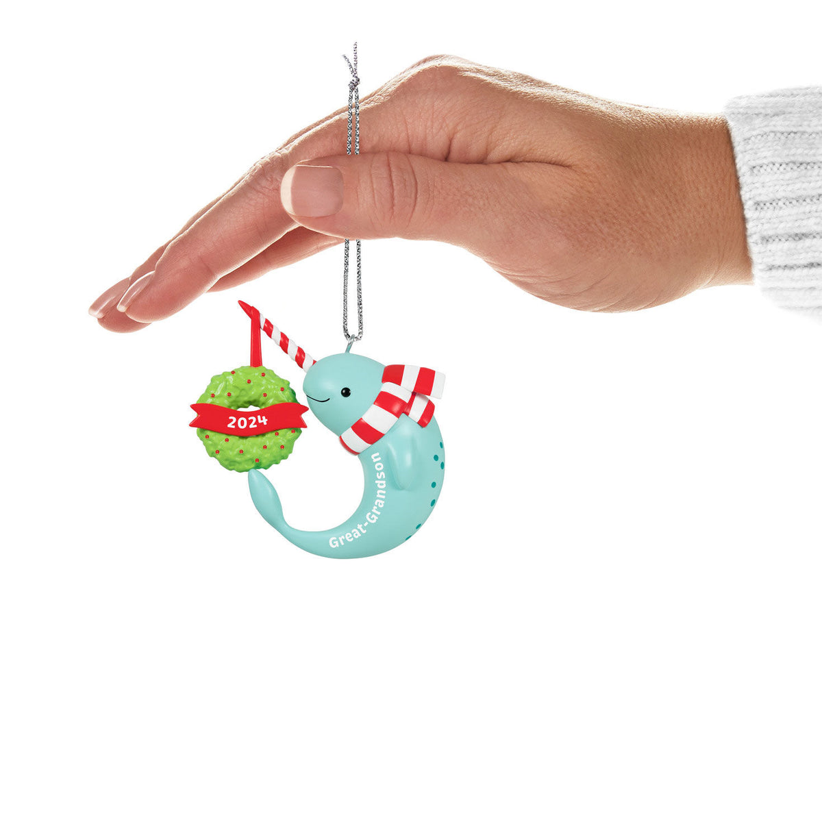 Great-Grandson Narwhal — Hallmark Keepsake Christmas Ornament, plastic decoration, blue colour, held by hand with green wreath detail.