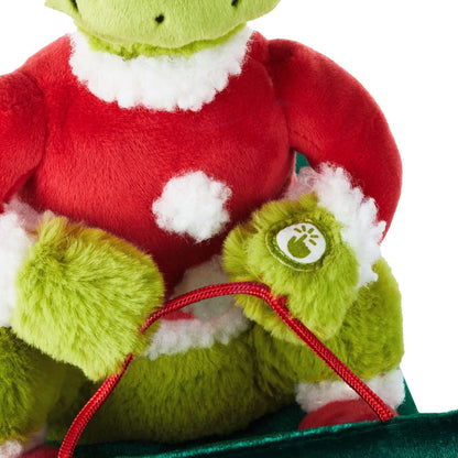 Dr. Seuss's How the Grinch Stole Christmas!™ Grinch on sled musical plush with motion, detailed view of Grinch's soft red Santa suit and green paws.