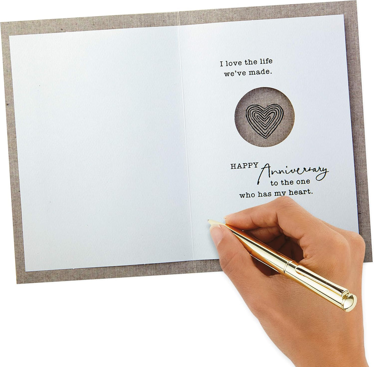 Hallmark Anniversary Greeting Card (Two Hearts) opened with heartfelt message inside, featuring a hand holding a pen.