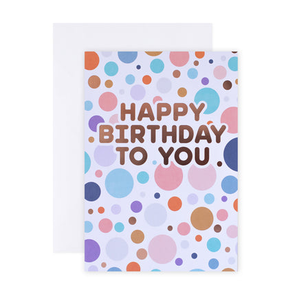 Hallmark Colossal Birthday Greeting Card - Colourful Spots featuring colourful spotted design and rose gold foil, flat lay with envelope.