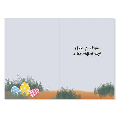 Greeting card with Easter eggs and grass illustration on a light blue background