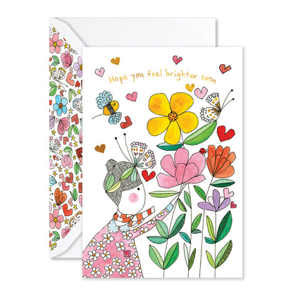 Greeting card with colorful illustrations of a person holding flowers and text 'Hope you feel brighter soon'.