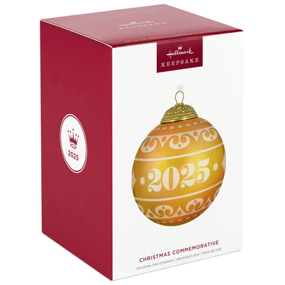 Christmas Commemorative, 13th in the Series — 2025 Hallmark Keepsake Christmas Ornament packaging with gold and yellow design, flat lay view.