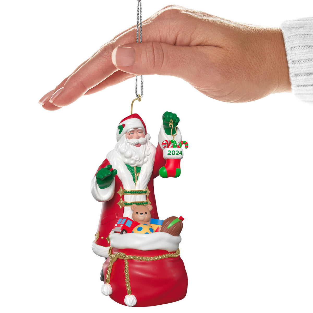 The Perfect Gift — Hallmark Keepsake Christmas Ornament featuring Santa holding a 2024 stocking, shown in hand for size reference.