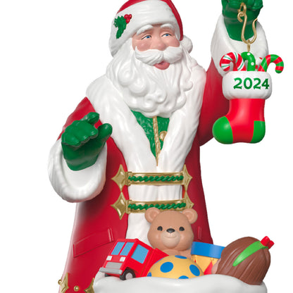 The Perfect Gift — Hallmark Keepsake Christmas Ornament, Santa holding a 2024 stocking, colourful toys, detailed facial features.