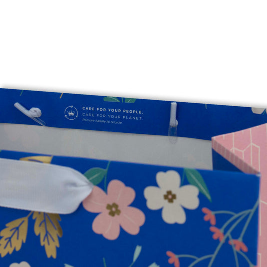 Hallmark Large Gift Bag - Sky Blue Floral featuring white ribbon handle and recycling instructions on the interior flap.