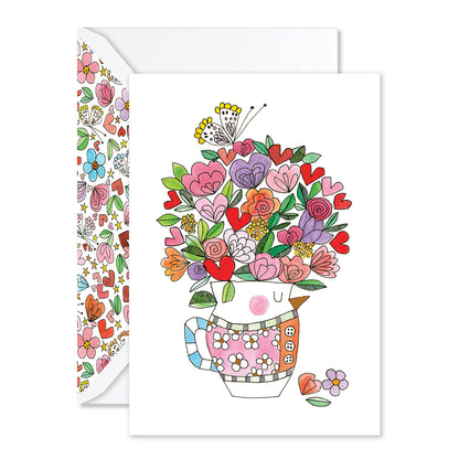 Greeting card with a colorful illustration of flowers in a teacup on a white background