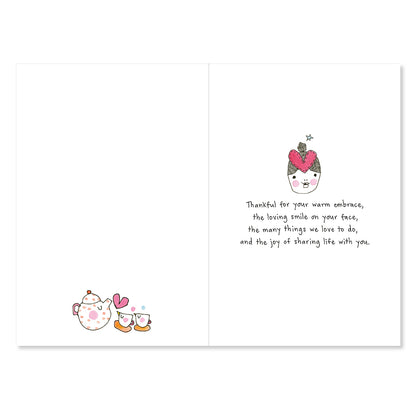 Greeting card with illustrations of a teacup and hearts, and text on a white background