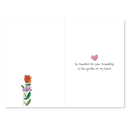 Greeting card with flowers and a heart on a white background
