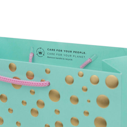 Hallmark Medium Gift Bag - Gold Bubbles, aqua gift bag with gold dots and pink cord handles, featuring recycling care instructions on the inside.