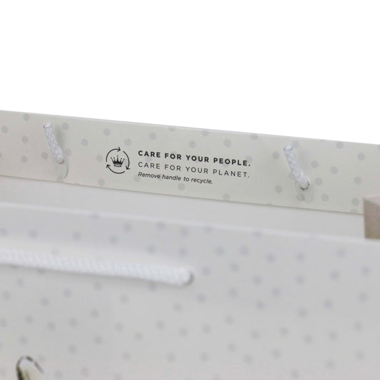 Hallmark Peter Rabbit™ large gift bag handles with recycling message and white cord detailing, top angle view.