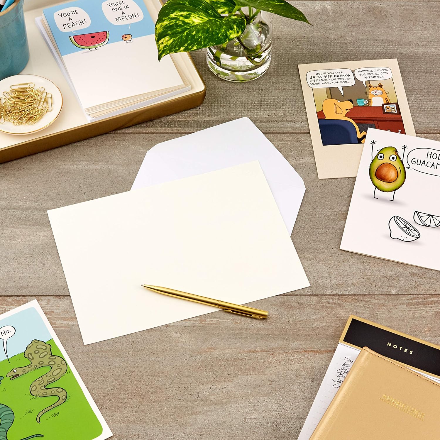 Hallmark Shoebox Funny Blank Cards Assortment (12 All Occasion Cards with Envelopes) arranged on a table with a gold pen, showcasing blank card design and envelopes.