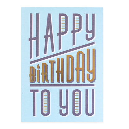 Hallmark Colossal Birthday Greeting Card - Gold & Bold featuring bold lettering on a light blue background, close up view.