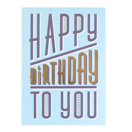 Hallmark Colossal Birthday Greeting Card - Gold & Bold featuring bold lettering on a light blue background, close up view.