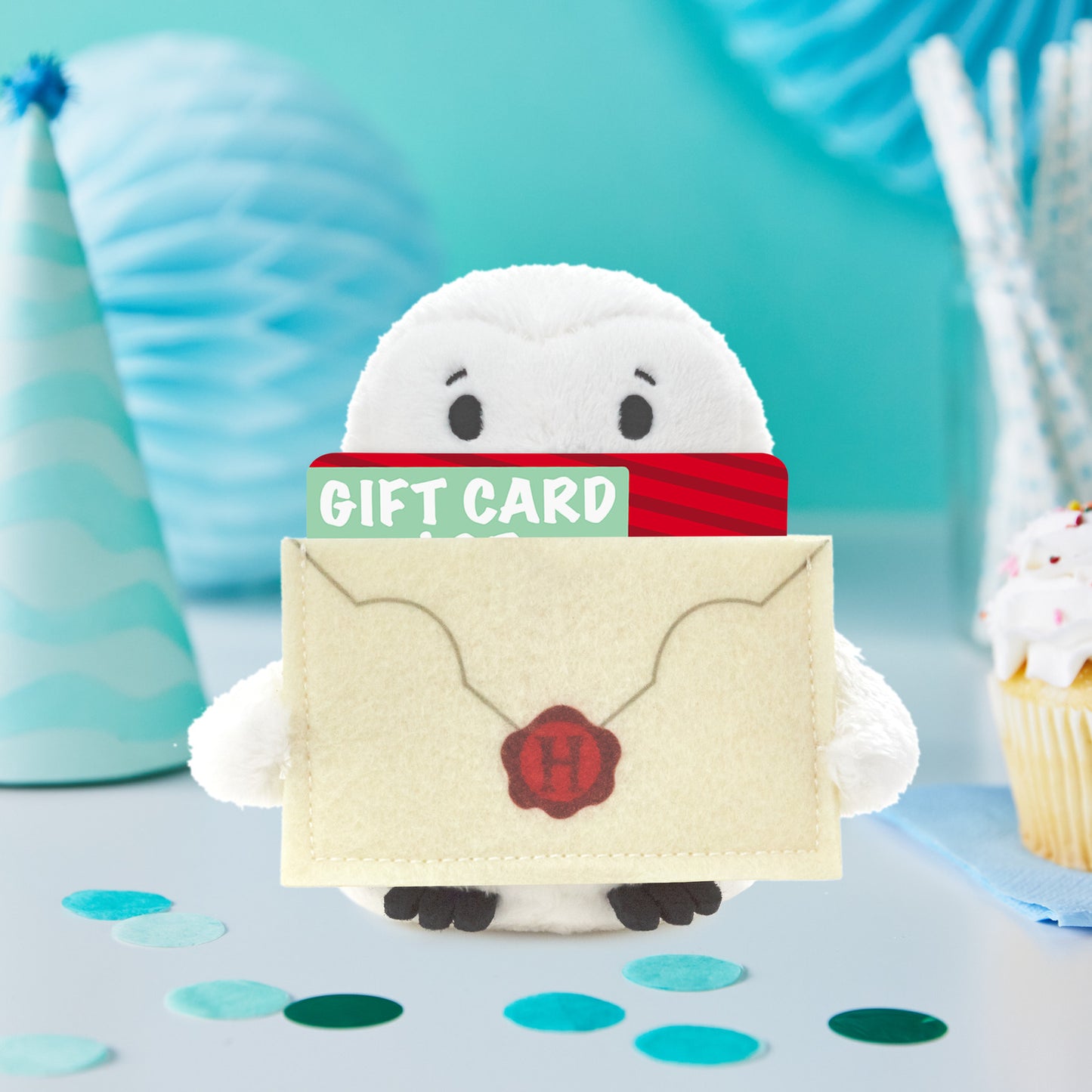 Harry Potter™ Hedwig™ Plush Gift Card Holder, 5" in a festive scene, holding a gift card in a cute envelope.