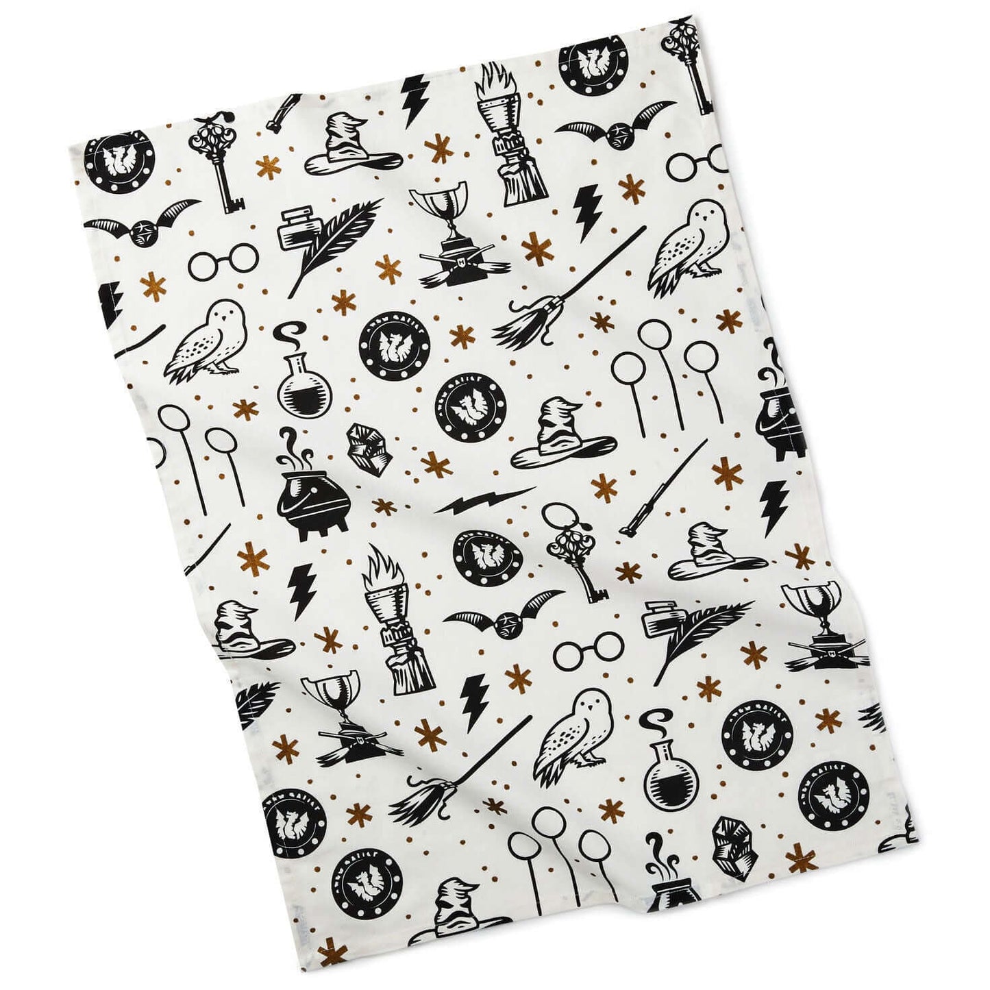 Harry Potter™ Wizarding World™ Icons Tea Towel in white cotton featuring black symbols and gold accents in a flat lay.