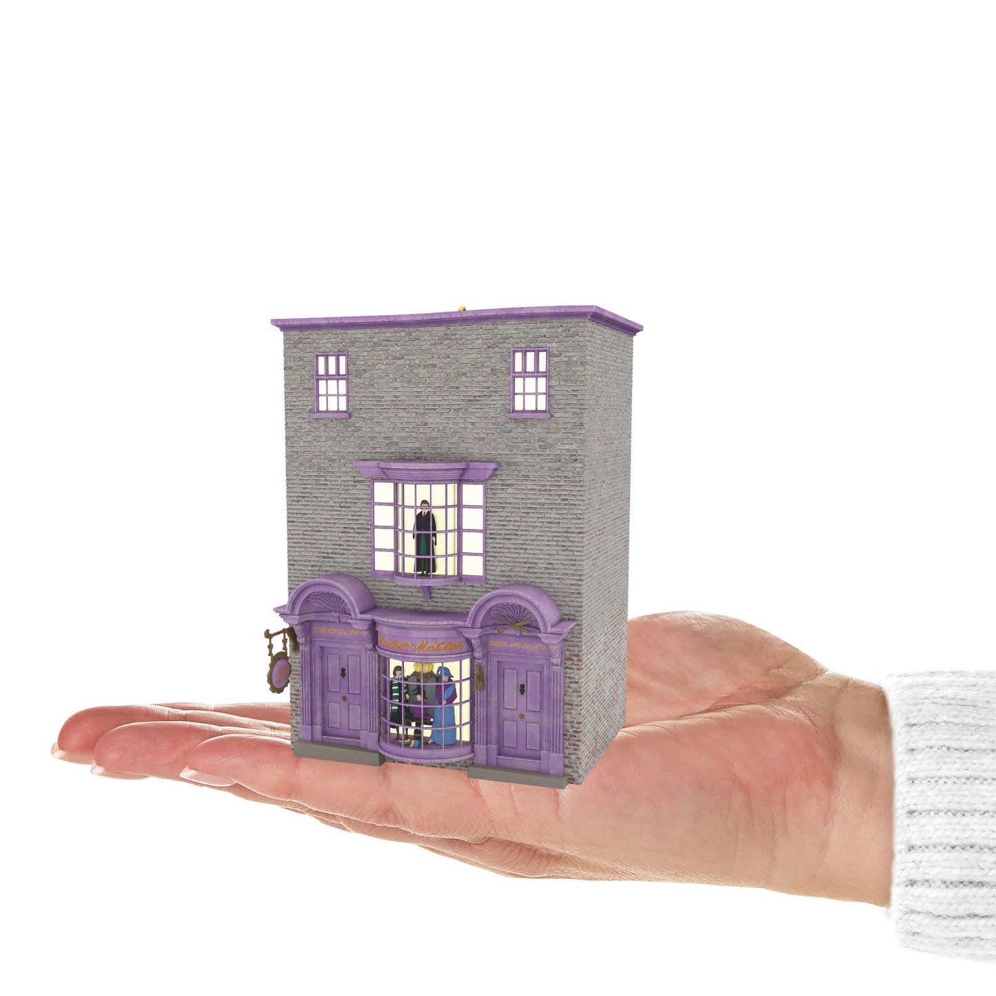 Harry Potter™ Madam Malkin's Robes for All Occasions™ — Hallmark Keepsake Christmas Ornament, miniature building model in hand, detailed facade.