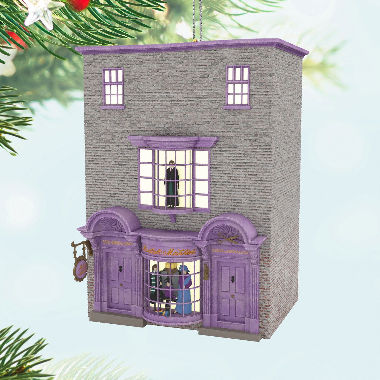 Harry Potter™ Madam Malkin's Robes for All Occasions™ — Hallmark Keepsake Christmas Ornament, detailed purple building with windows, festive background.