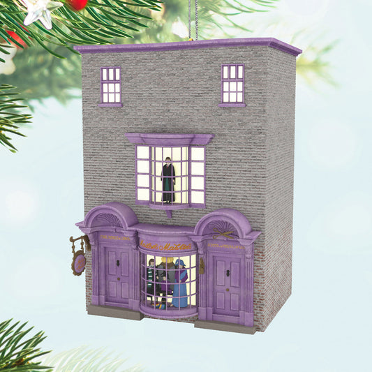 Harry Potter™ Madam Malkin's Robes for All Occasions™ — Hallmark Keepsake Christmas Ornament, detailed purple building with windows, festive background.