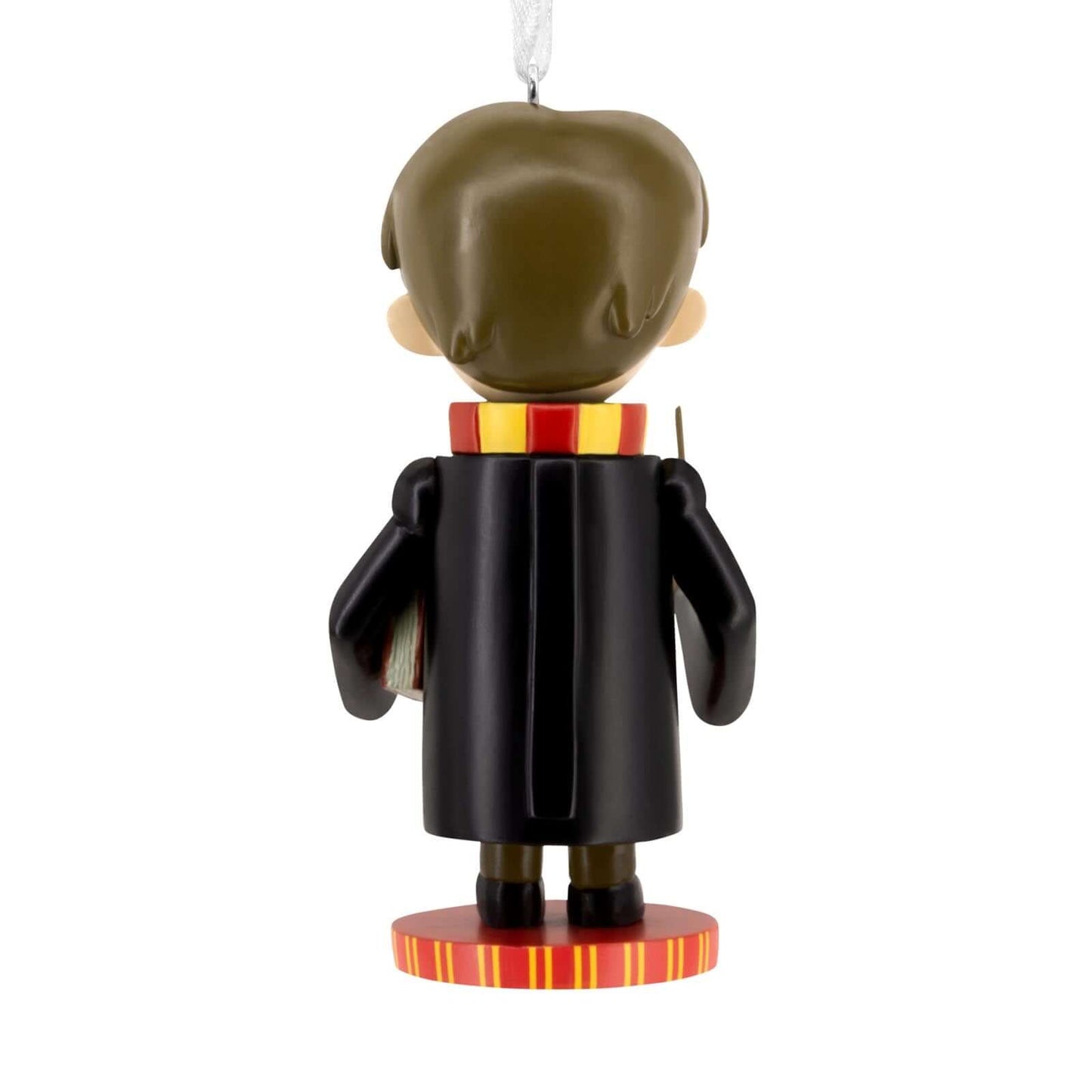 Harry Potter Nutcracker - Hallmark Christmas Ornament in black robes with Gryffindor scarf, back view, hanging on a tree