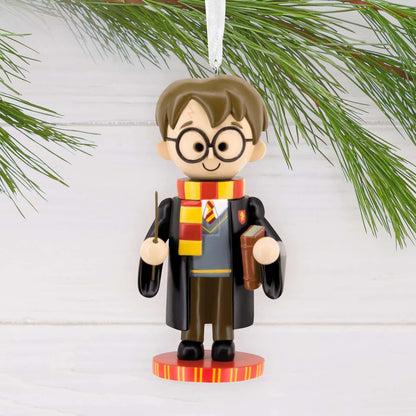 Harry Potter Nutcracker - Hallmark Christmas Ornament, colourful figurine of Harry in Gryffindor robes and scarf, hanging from a pine branch.