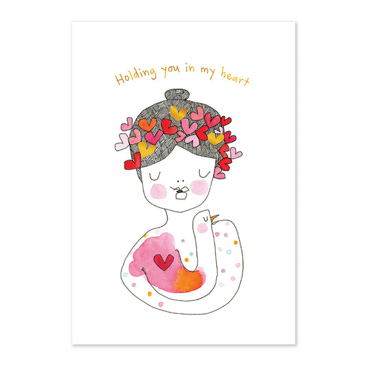 Illustration of a woman with heart-shaped flowers in her hair and text 'Holding you in my heart' on a white background.