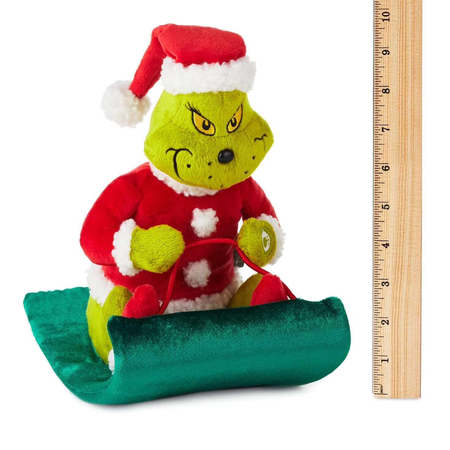 Dr. Seuss's How the Grinch Stole Christmas!™ Grinch on sled musical plush with motion in Santa suit, 25 cm tall, with measuring ruler