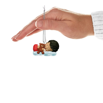 Mary's Angels Poppy — Hallmark Keepsake Christmas Ornament held above a soft cloud, featuring a sleeping child with teddy bear, flat lay