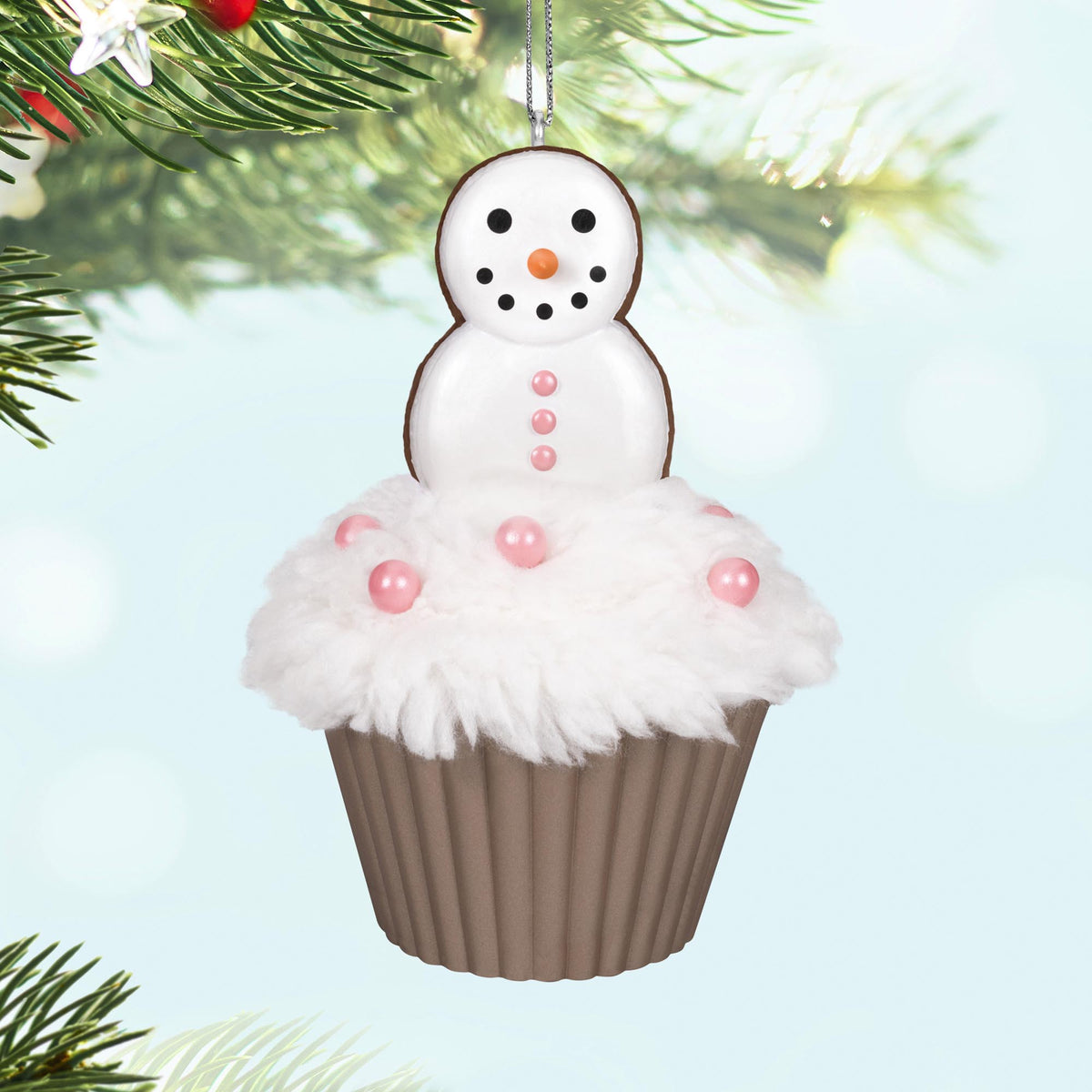Merry Macarons, 16th in the Christmas Cupcakes Series — 2025 Hallmark Keepsake Christmas Ornament, featuring a snowman on fluffy icing with pink pearl candies, close up.