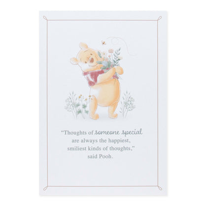 Hallmark Disney Winnie the Pooh Mother's Day card featuring Pooh hugging flowers, with a heartfelt quote in soft colours.