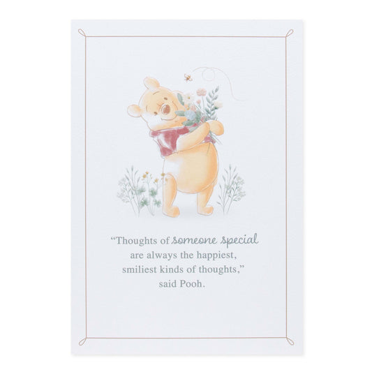 Hallmark Disney Winnie the Pooh Mother's Day card featuring Pooh hugging flowers, with a heartfelt quote in soft colours.