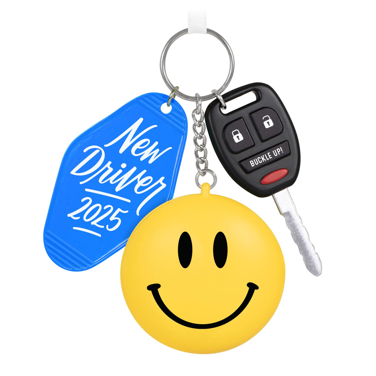 New Driver — 2025 Hallmark Keepsake Christmas Ornament featuring a blue keychain, car key, and a smiling face, flat lay view.