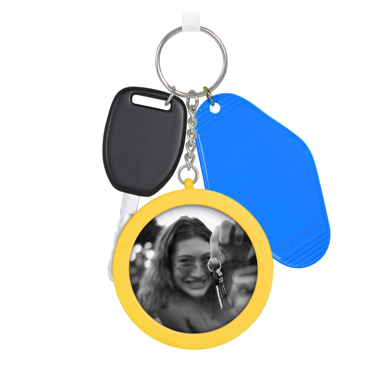 New Driver — 2025 Hallmark Keepsake Christmas Ornament featuring a yellow keychain with a photo frame and car keys, flat lay view.