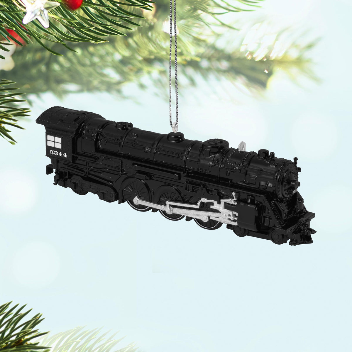 New York Central 700E Hudson Locomotive, 30th in the LIONEL® Trains Series — 2025 Hallmark Keepsake Christmas Ornament, black detail, hanging on pine bough.