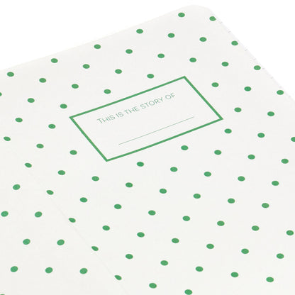 Next Chapter Notebook with white cover featuring green polka dots and a space for writing the story title, flat lay view.