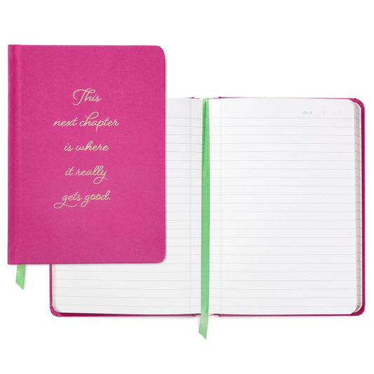 Next Chapter Notebook in fuchsia hardcover with gold foil lettering and green ribbon bookmark, showing lined pages and cover message.
