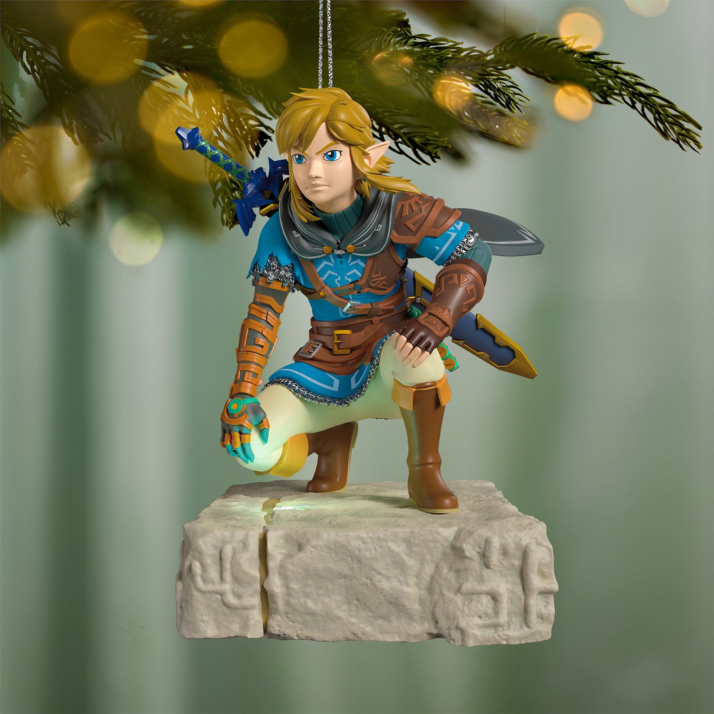 Nintendo The Legend of Zelda™: Tears of the Kingdom Link Musical With Light — 2026 Hallmark Keepsake Christmas Ornament featuring Link crouching on a stone base with glowing detail.