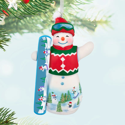 Ollie U. Halfpipe, 21st in the Snowtop Lodge Series — 2025 Hallmark Keepsake Christmas Ornament, porcelain snowman with snowboard, festive colours, close-up view.