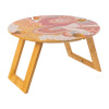 Abstract foldable picnic table with a floral-patterned top and natural wooden legs, angled view to highlight design.